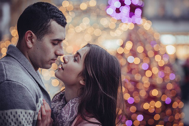 couple kissing in front of tree