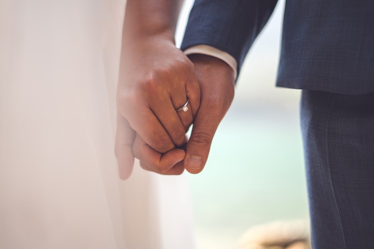 couple in formalwear holding hands