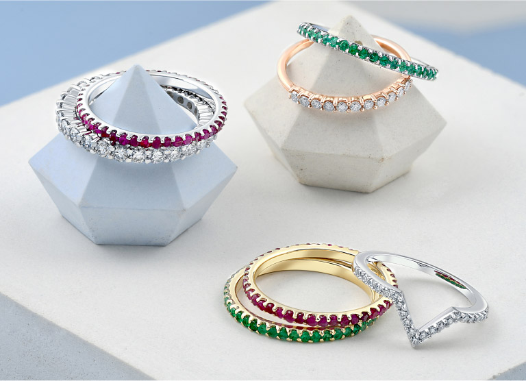 a variety of colorful gemstone stacking rings