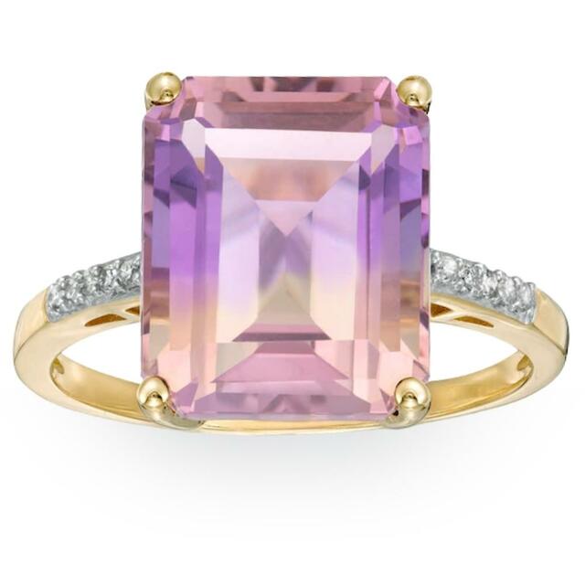a gold and diamond ring with a pink gemstone