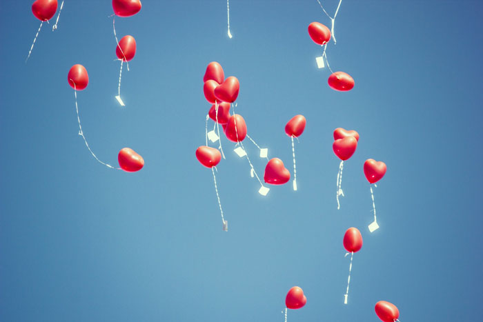 red heart balloons in the sky