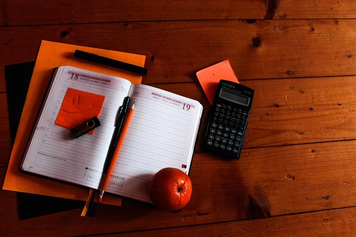 planner on desk with calculator