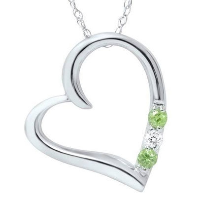 silver heart pendant with two peridot and one clear stone