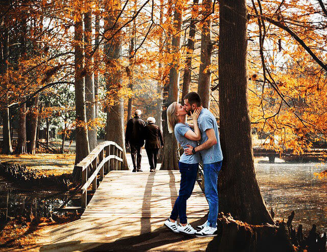 couple kissing outdoors in fall