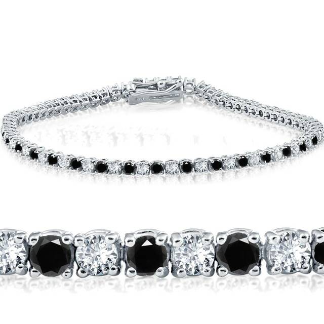 a silver tennis bracelet with diamonds and black gemstones