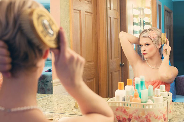 woman in mirror with pearls